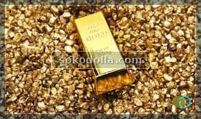 Raw alluvial gold grains with a small cast gold bar